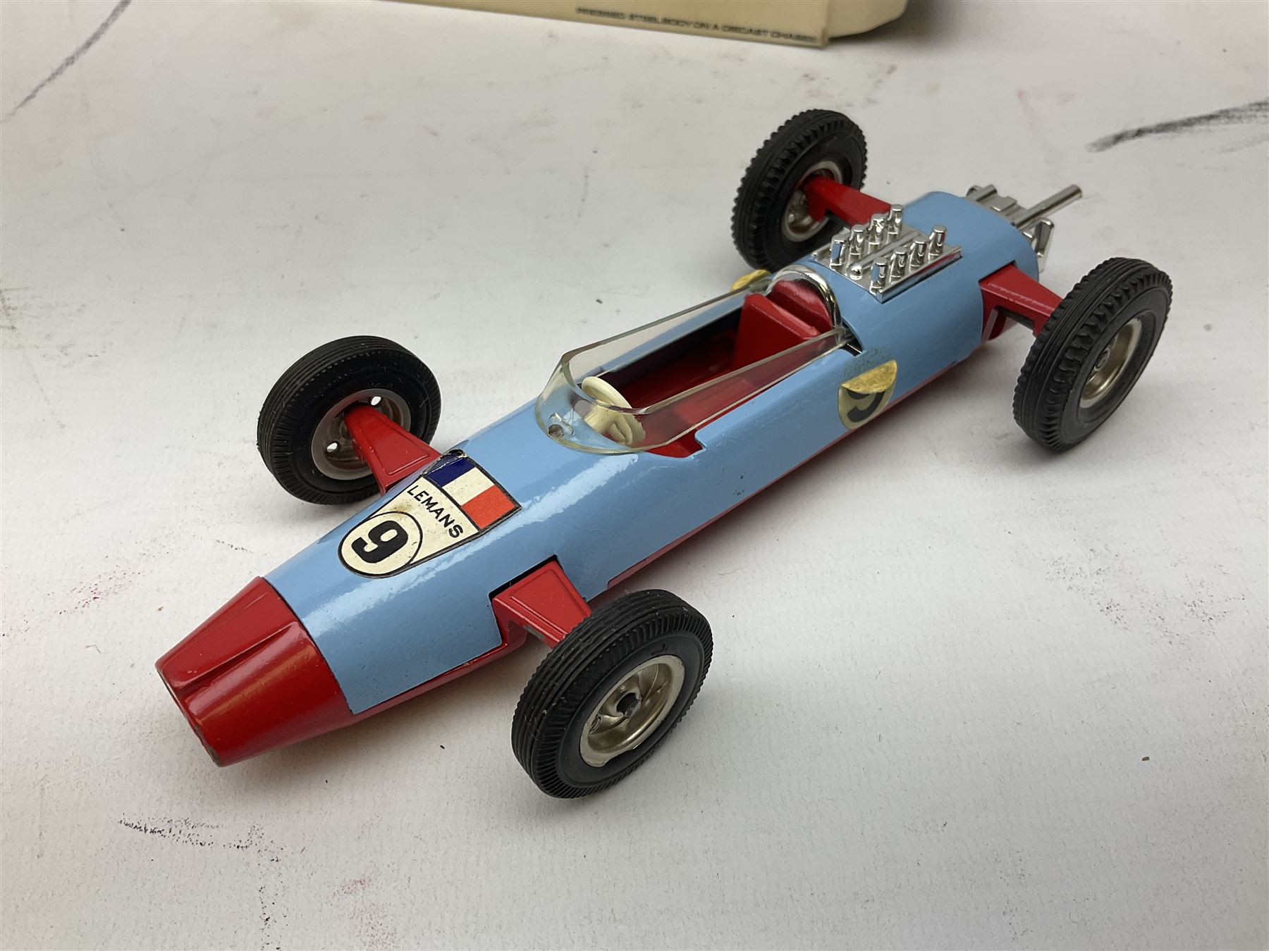 Various makers - Tri-ang Mini-Hi-Way Racing Car Series Le Mans No.9 racing car; Matchbox K-15 Merryweather Fire-Engine; Marx tin-plate Friction Helicopter; all boxed; and a Minic Motor Rally Adventure box containing a Jaguar Police car for spares or repair (4)