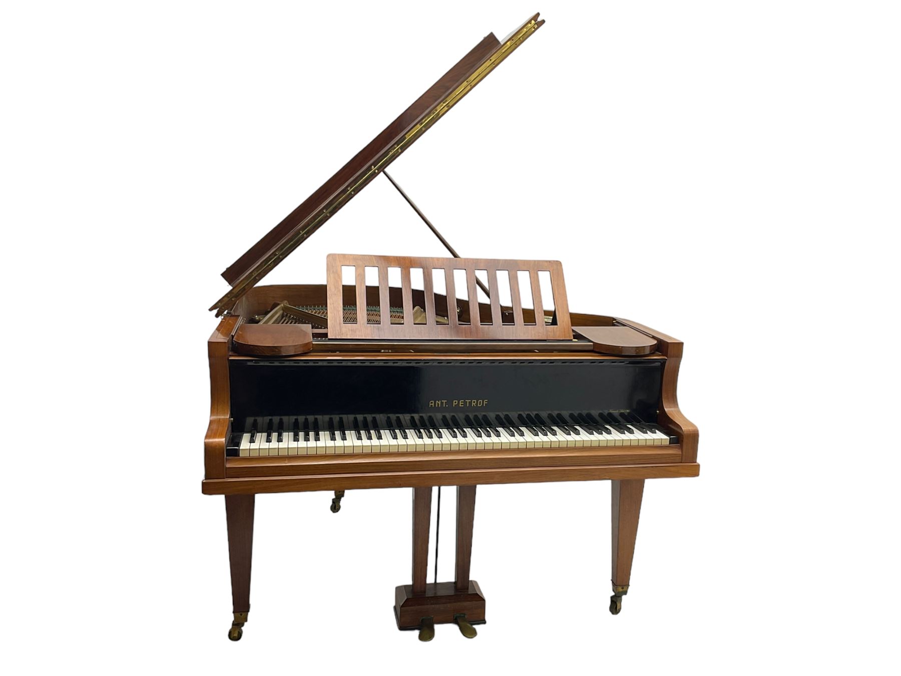  Antonin Petrof - Walnut overstrung baby grand piano, 7 0catve 85 key compass with original strings, tuning pins, damper felts and hammer heads, with roller keyboard action and iron frame, sustaining and una-corda pedals, sliding open lattice music desk, supported on square tapering legs with brass cups and castors, with inner ebonised key fall and ivorine label inscribed 'Supplied by Harrods, London'.