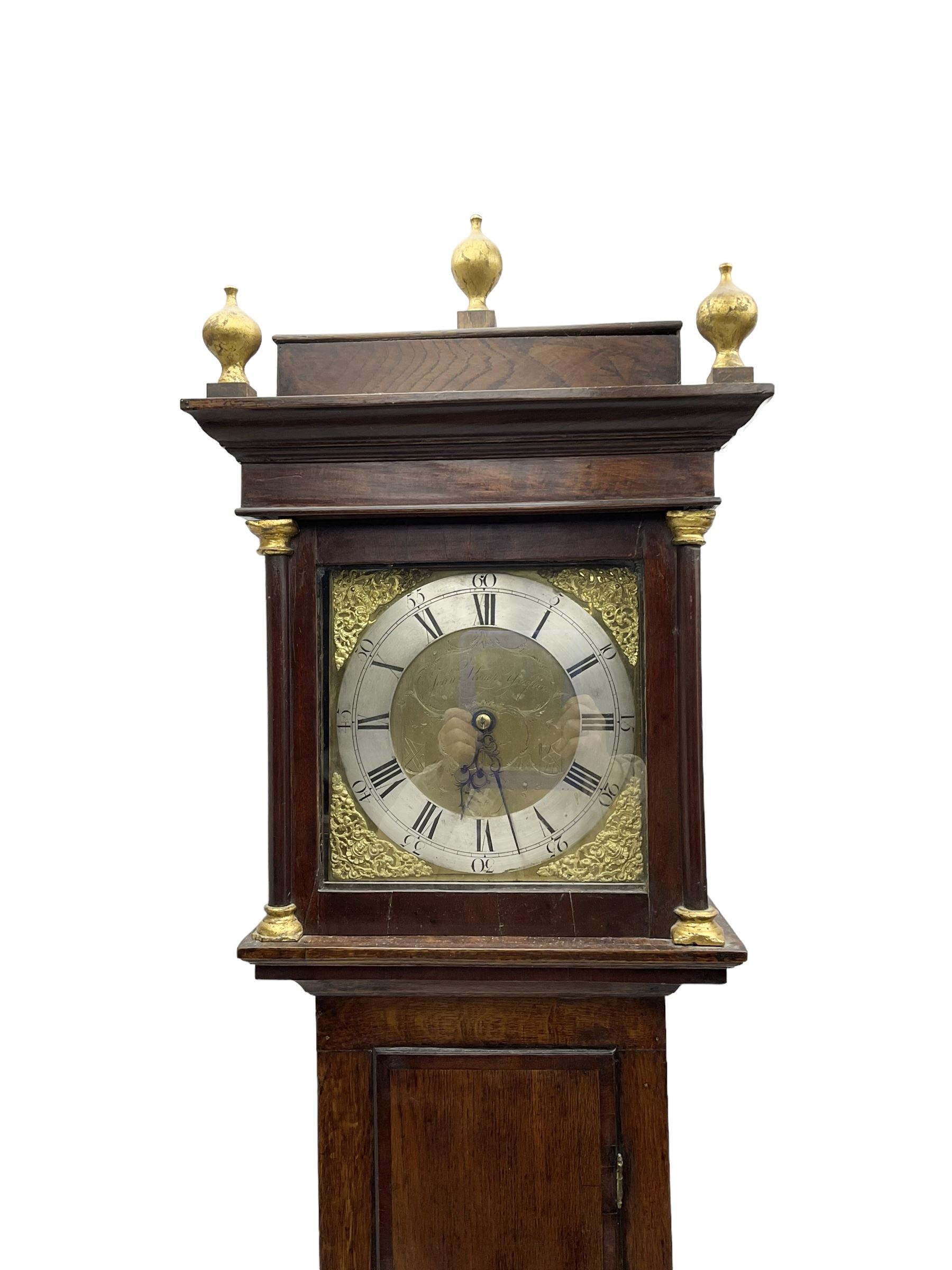 John Kemp of Yoxford (Suffolk) - 18th century oak 30 hour longcase clock c1770, with a later box top and finials, square hood door with attached pilasters and gesso capitals, long flat topped trunk door with a rectangular plinth and bracket feet, brass dial with cast spandrels and engraved dial centre, silvered chapter ring with Roman numerals and five minute Arabic's, with matching steel hands, birdcage chain driven movement with a recoil anchor escapement and count wheel striking. With weight and pendulum.
