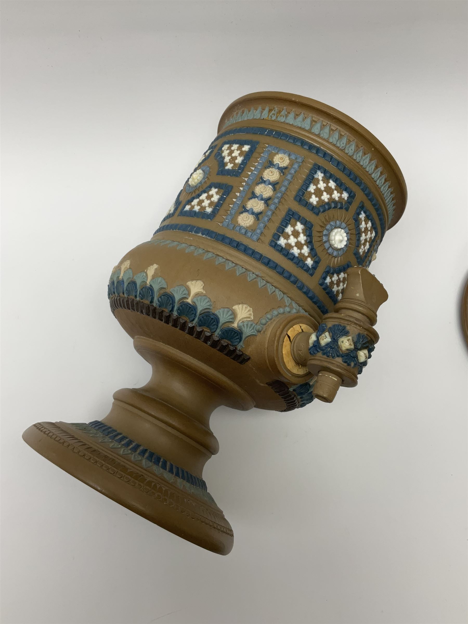 A late 19th century Doulton Lambeth stoneware water filter with original spigot, decorated with relief moulded foliate bands, with impressed marks and monogrammed for Laura Gooderham beneath, H34cm. 
