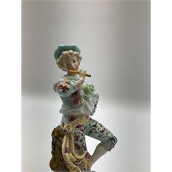 Pair of German porcelain figures, modelled as a man playing the flute and the woman dancing with a flan, upon naturalistically modelled circular base with C scroll detail, blue underglaze mark beneath and impressed 'EBS 7265', H25.5cm