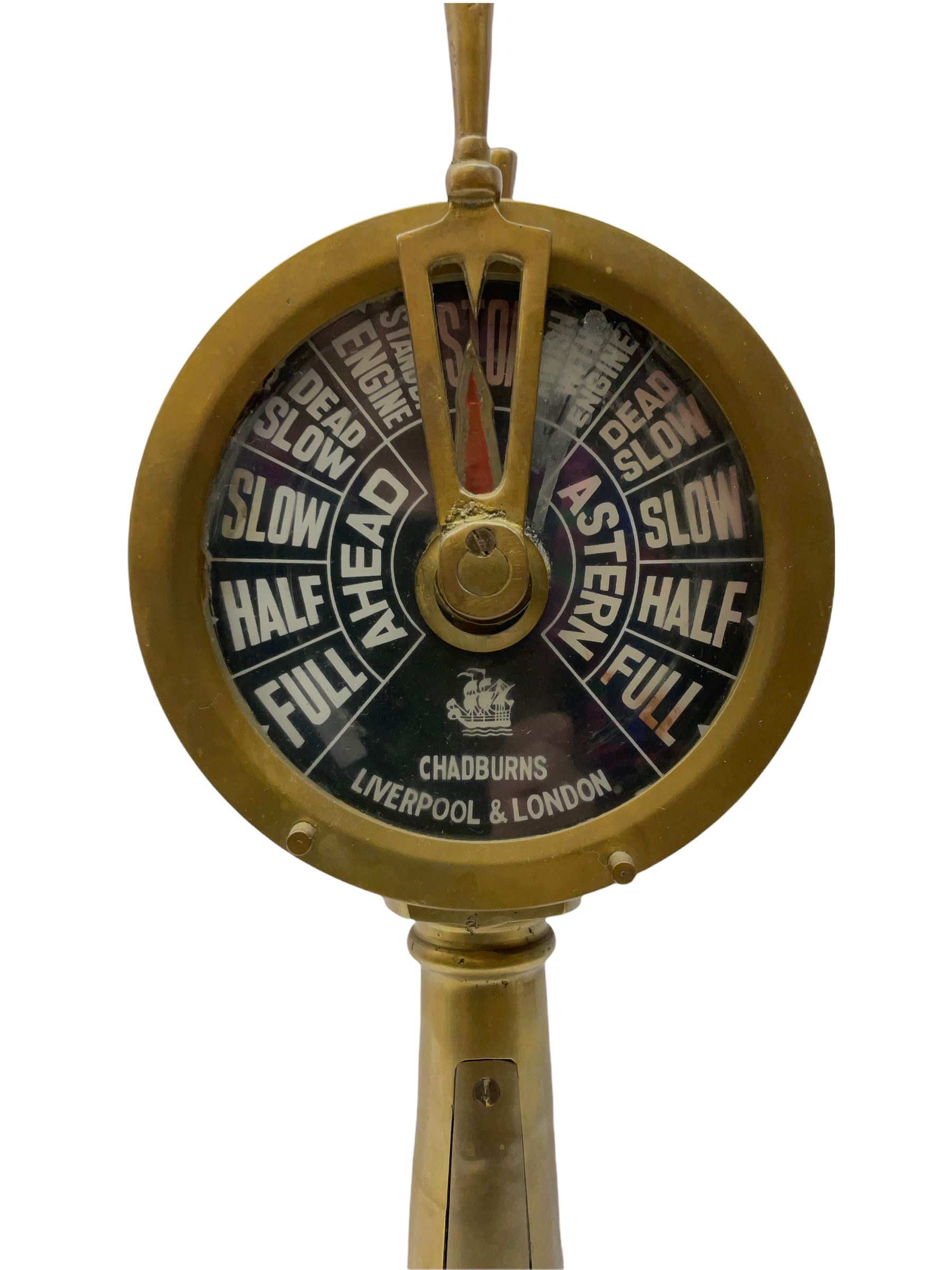 Early 20th century, illuminating brass ship's telegraph by Chadburns of Liverpool and London, on a circular wooden plinth, H55cm
