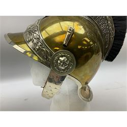 Early 20th century French mounted gendarme's helmet, brass with nickel-silver mountings, broad band embossed with fused grenade, high comb with the face of the gorgon Medusa at the peak and with a black horse hair crest, plume socket at the left, leather-backed nickel-silver chin scales with lion mask mounts.