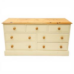 20th century painted pine chest, rectangular top over an assortment of seven drawers, on skirted base