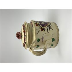 18th century creamware teapot, probably Leeds, with reeded entwined handle and floral finial to the cover, the body with hand painted polychrome decoration of figure to one side, and floral spray to the other, collectors paper label beneath inscribed Leeds Pottery, H11.5cm