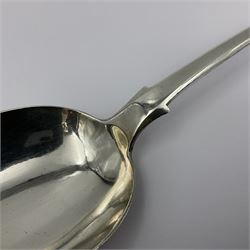 Victorian Newcastle silver Fiddle Shell pattern serving spoon, the terminal engraved with crest of a fist holding an arrow aloft, hallmarked Lister & Sons, Newcastle 1862, L31cm