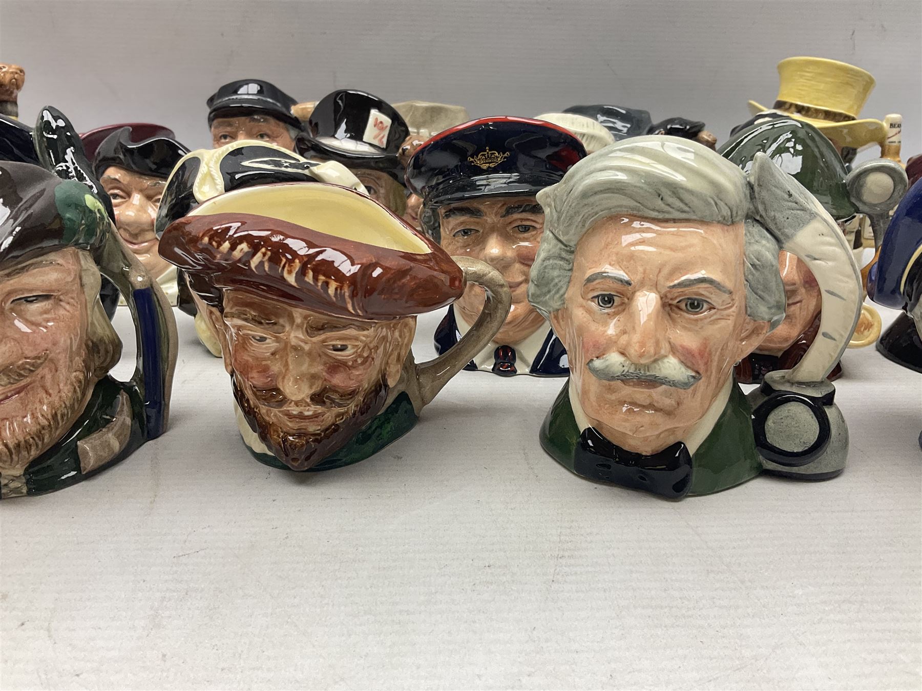 Large collection of Royal Doulton miniature character jugs, to include The Postman D6801, The London 'Bobby' D6762, Old Salt, D6554, Sir Henry Doulton D6703 etc  