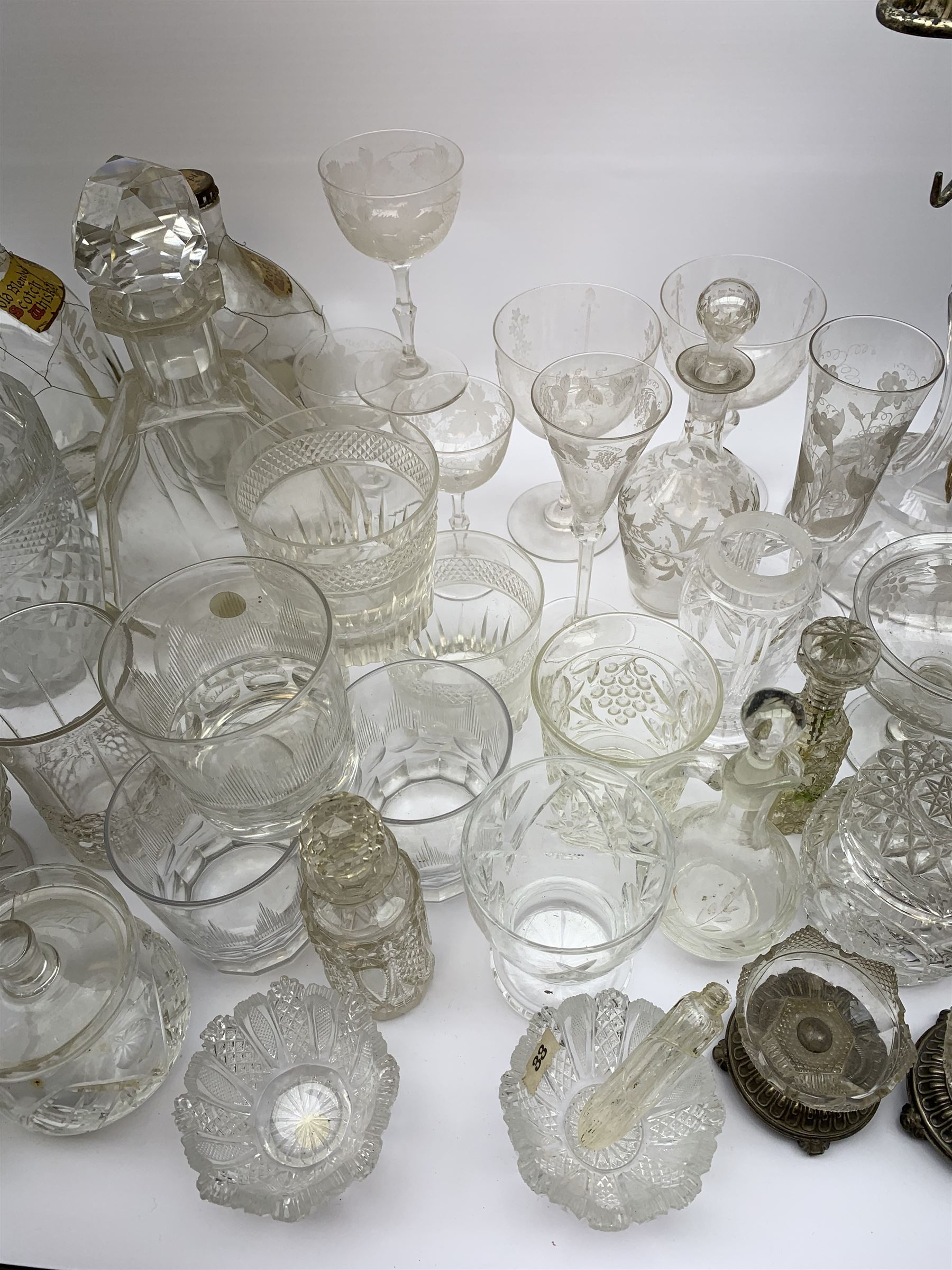 A number of Victorian tumblers and Edwardian drinking glasses, together with a large quantity of other later glassware, to include a glass table lamp base, drinking glasses of various forms, a number with cut decoration, other assorted cut glass including jug, vases, jars and covers, etc. 
