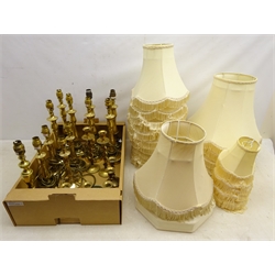  Five pairs of brass candlestick lamps, three pairs of brass candlesticks, single candlesticks & lamps with a set of twelve shades, set of six smaller shades and others   