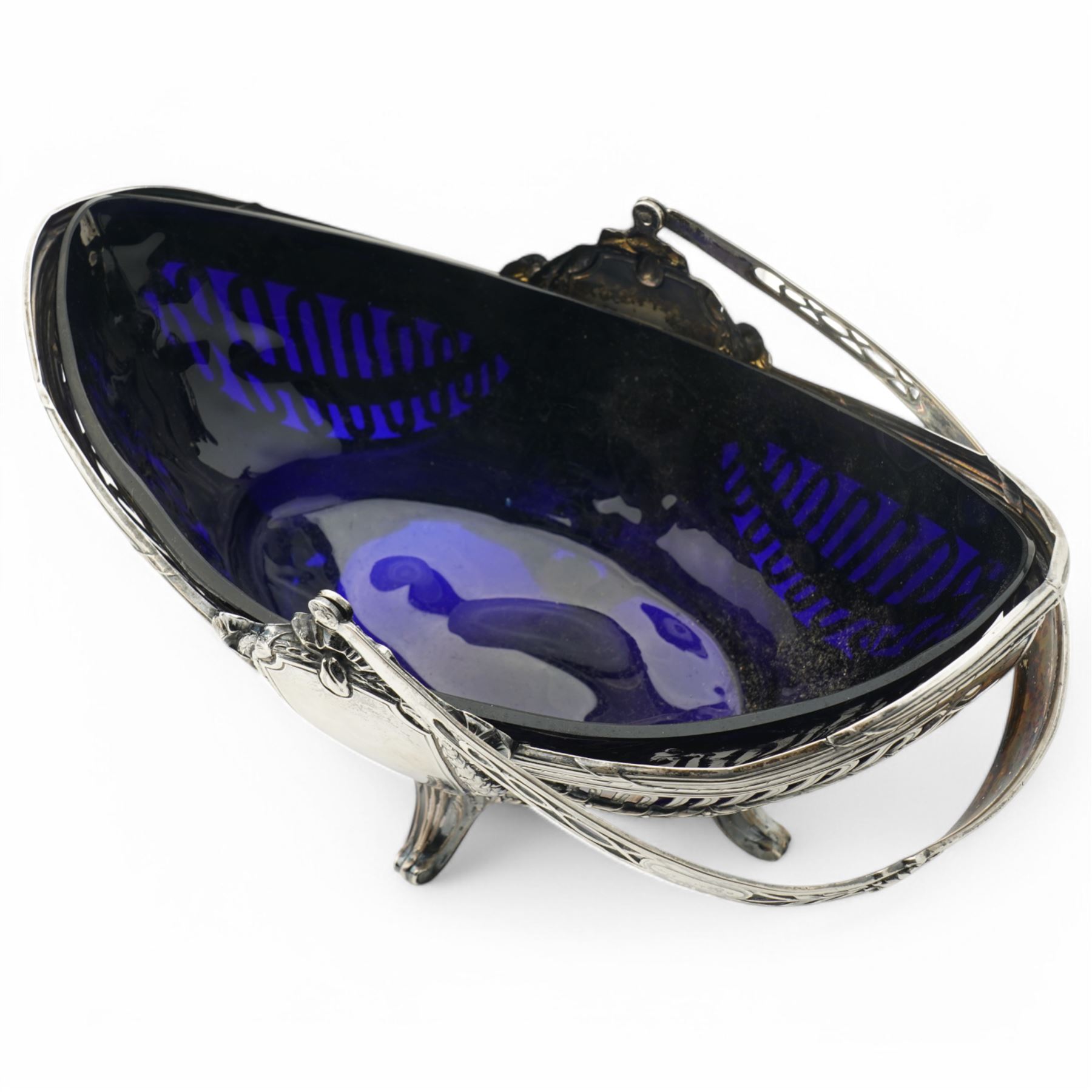 German standard 800 silver oval centrepiece with pierced sides, trailing harebells and swing handle, blue glass liner on splay feet L29cm Maker Wilhelm Binder