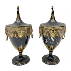 Pair of Georgian tole chestnut urns and covers, with lion mask handles, decorated with gilt detail, the sharply upswept cover topped with acorn finials, H31cm