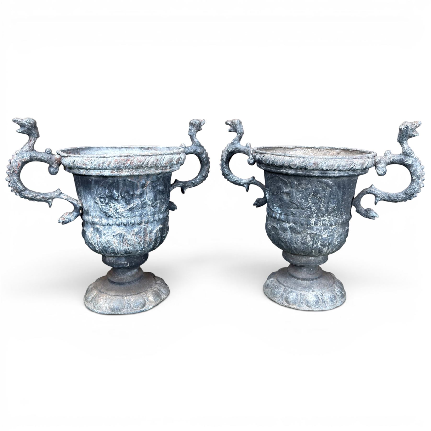 Impressive pair of early highly decorative lead garden urns, griffin handles with ornate decoration depicting cherubs and laurel wreath