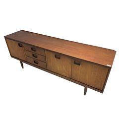 William Lawrence of Nottingham - mid-20th century teak sideboard, with low gallery back over three short drawers and a fall front, flanked by two cupboard doors, enclosing shelves, raised on tapering cylindrical supports, makers mark stamped inside drawer