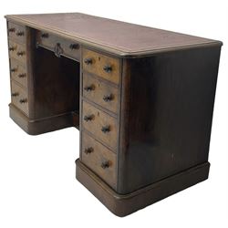 Victorian figured walnut kneehole desk, moulded rectangular top with inset leather writing surface, fitted with nine drawers, the central frieze drawer with carved curled foliage mount, on moulded plinth base,