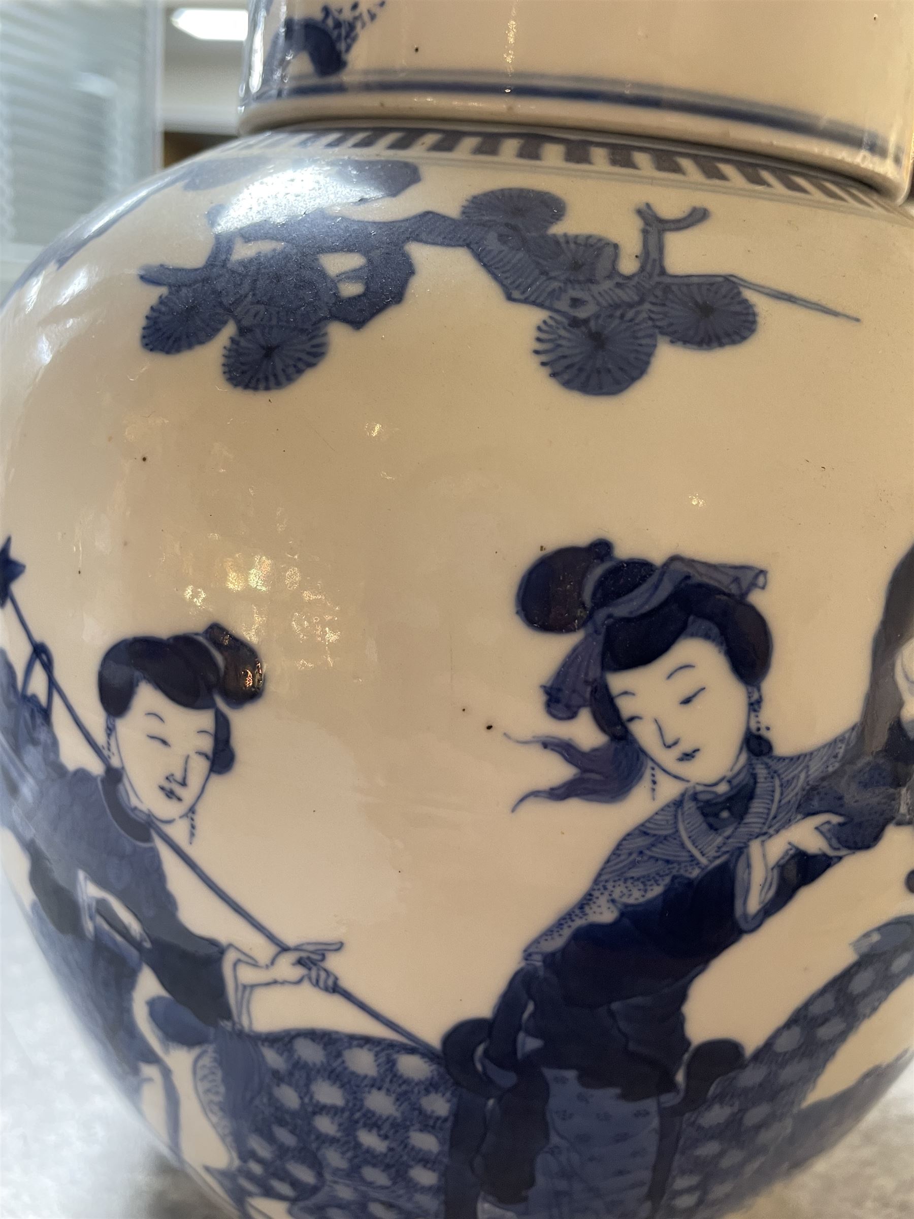 Late 19th century Chinese blue and white ginger jar, of ovoid form with flat topped circular cover, the body decorated with a geisha on reindeer with attendant in a landscape setting, with apocryphal Kangxi mark beneath, H24cm
