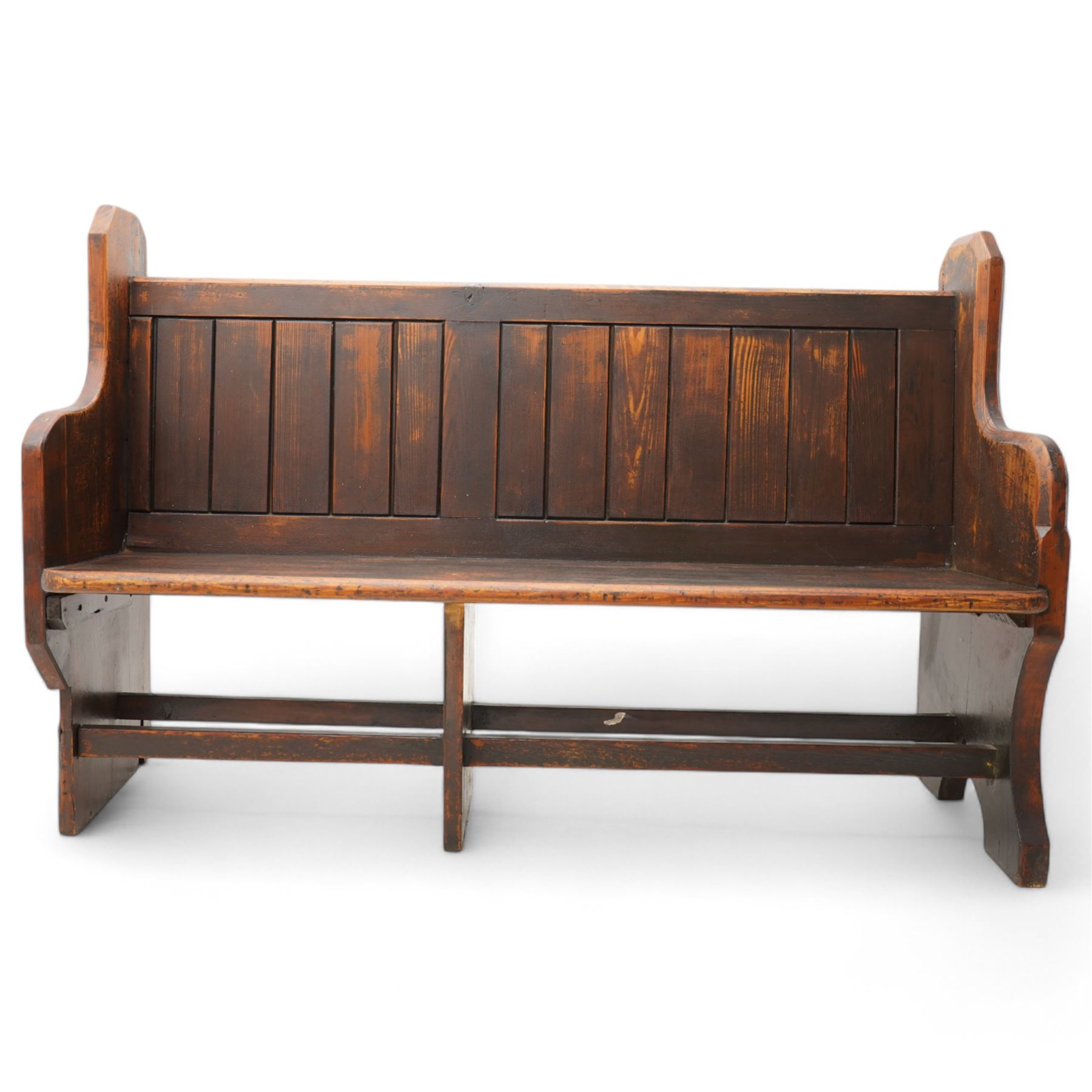 Victorian pine pew or bench, panelled back with book raised over plank seat, on shaped end supports united by stretcher 