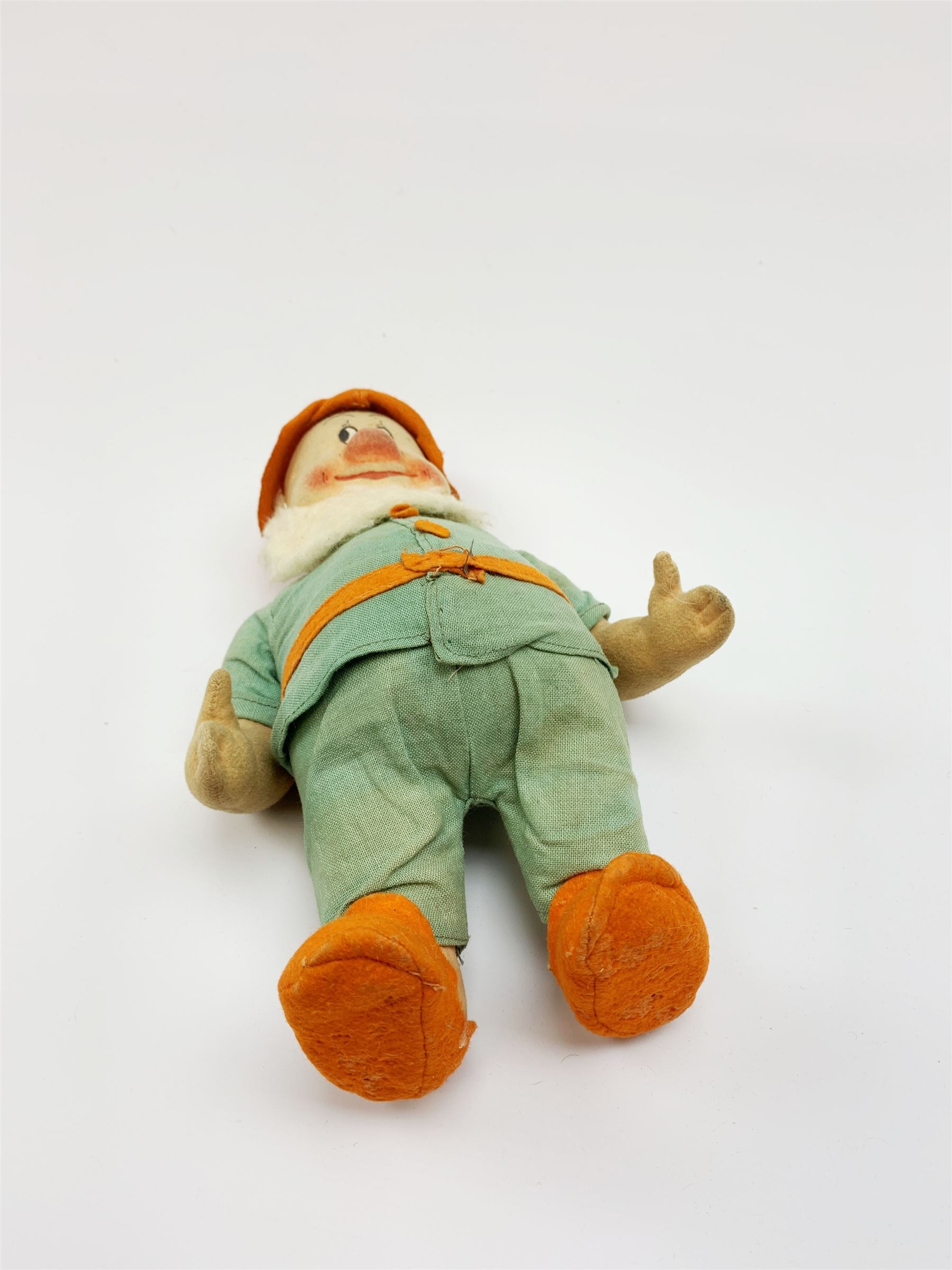 Chad Valley pressed felt figure of the Disney Snow White dwarf 'Doc' with painted facial features, standing wearing a green linen suit with orange hat, belt, buttons and shoes H13