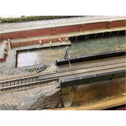 'Z' gauge continental scenic layout with folding legs, various loops of track and sidings with overhead cables, buildings including water tower, tunnels, roads with motor vehicles and figures, trees, haven with boats, backdrop diving wall hiding control units 150 x 50cm