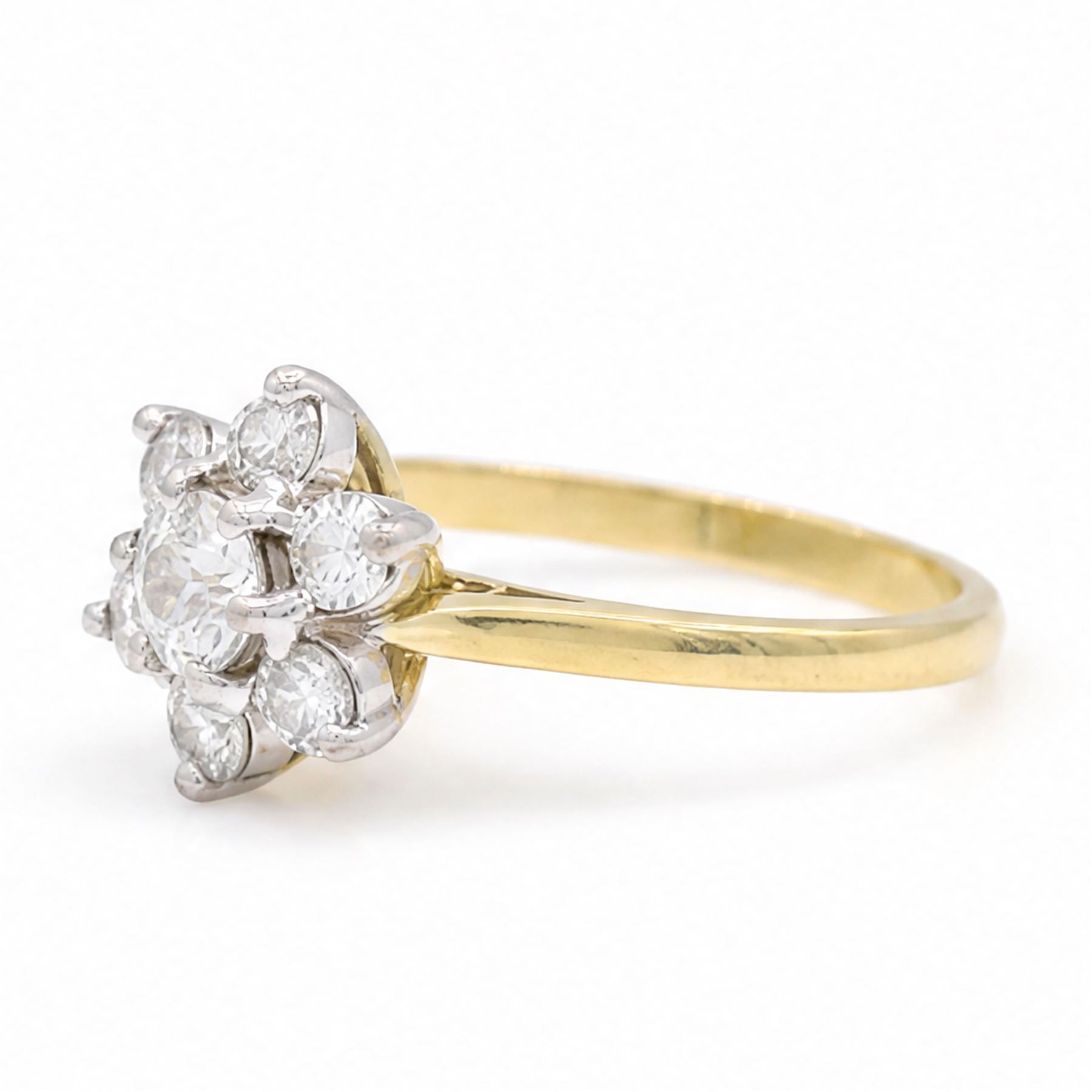 18ct gold diamond flower head cluster ring, principal round cut diamond of approx 0.55 carat, surrounded by six round brilliant cut diamonds, hallmarked, total diamond weight 1.15 carat