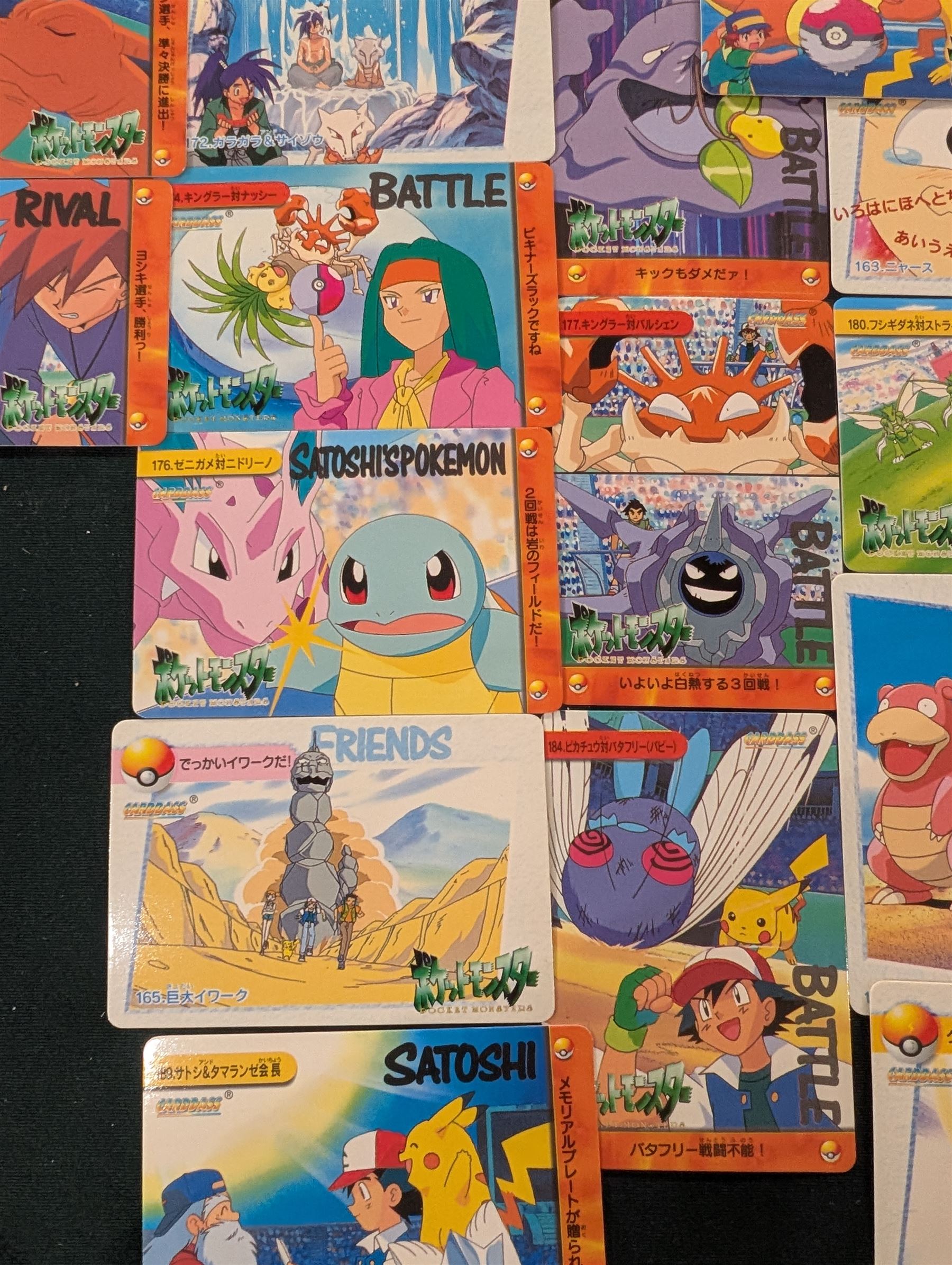 Collection of Pokemon TGC trading cards, including two WB First Movie Black Star promo cards Pikachu no. 4 and Dragonite no. 5, two Ancient Mew Black Star holo promo cards, Gym Challenge Giovanni's Persian 8/132 holo and a small collection WOTC, Neo Discovery and Neo Genesis cards, together with thirty four Bandai Carddass Pokemon cards, including prism Charizard no. 186 and Pokemon Topps cards including holo examples 