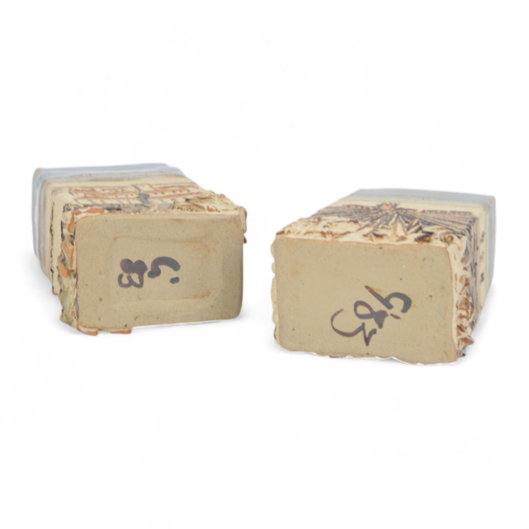 Robin Gough; two studio pottery vases of rectangular chimney vase, each decorated in relief with villages, H15cm 
