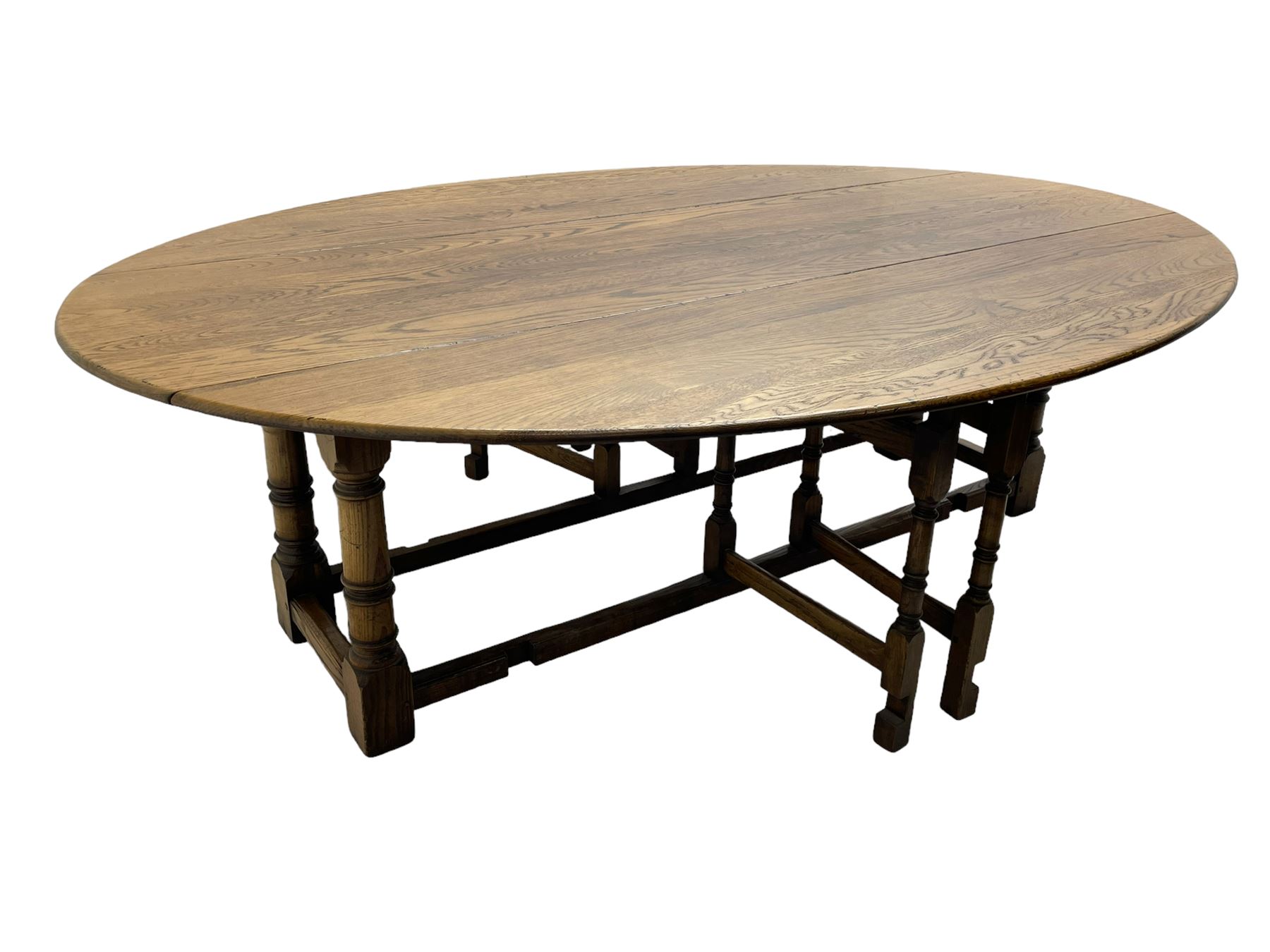 Large 18th century design oak wake or dining table, oval drop-leaf top, turned supports with double gate-leg action base, united by moulded stretchers 