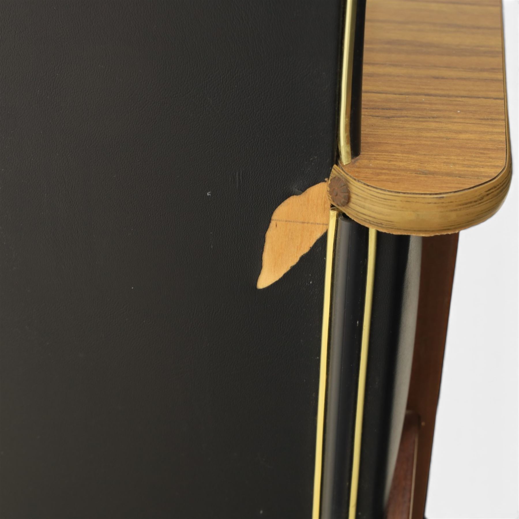 Barget of London - Mid 20th century L-shaped teak and black vinyl cocktail bar, shaped top with gilt metal banding and black cushioned edge over glazed upper section and open serving shelf, the reverse fitted with shelves, the front with applied lattice mouldings over black vinyl, on plinth base
