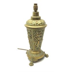 A brass table lamp, of tapering form, the pierced body detailed with stylised classical figures within a scrolling surround, raised upon three paw feet, H40.5cm. 