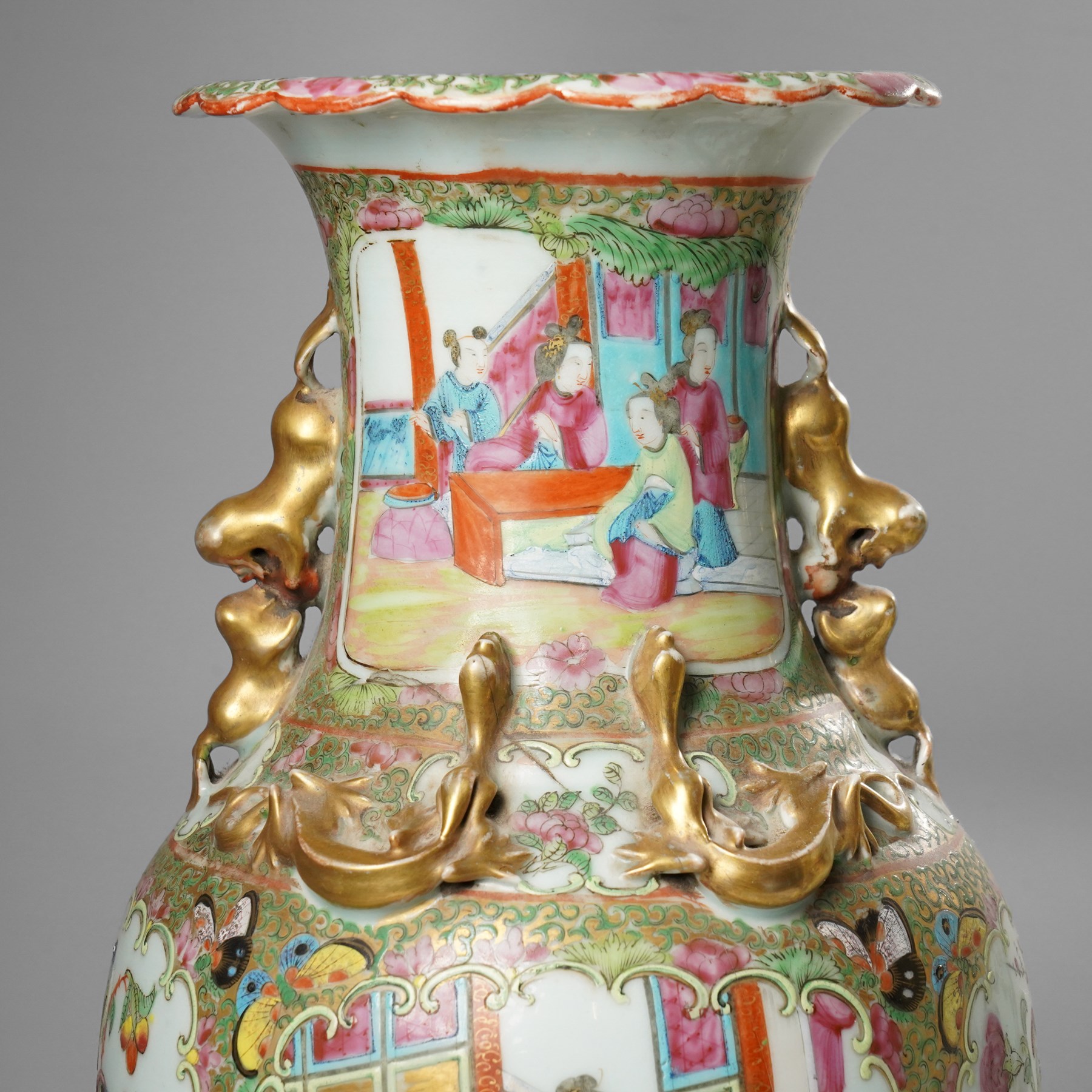 Cantonese famille rose vases, of inverted baluster form, the domed cover with gilt dog of Fu finial, H38cm; together with a further pair of Cantonese vases, each with double Buddhist lion handles and applied at the shoulders with chilong, H45cm (3)
