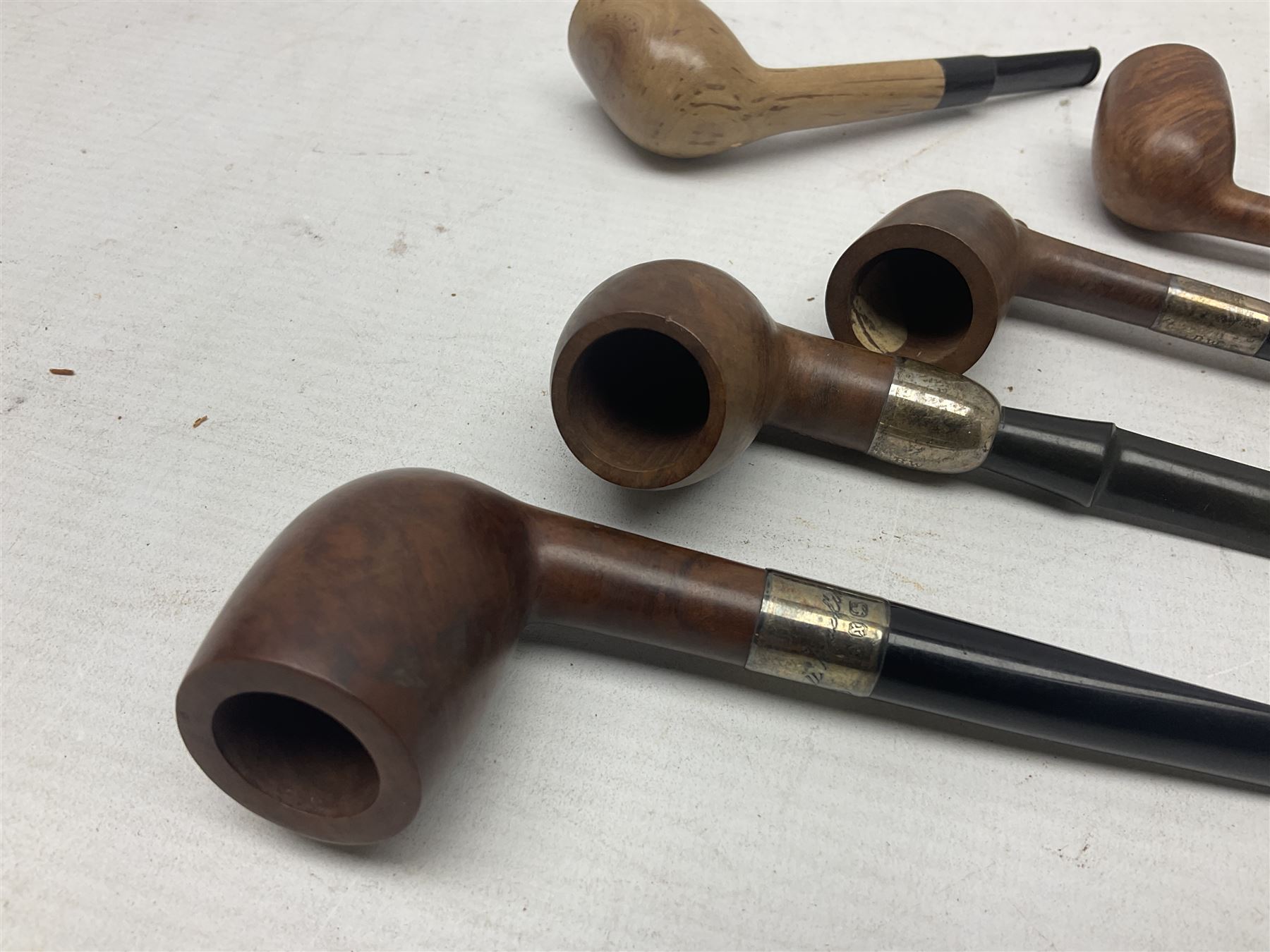 Collection of eight silver mounted pipes, comprising a briar wood Imperial ITC example with silver collar hallmarked A.W Birmingham 1903, horn handled example with silver collar hallmarked LB, probably Louis Blumfeld, Birmingham 1900, three examples marked B.W, one marked Globe A.O.C, Blumfeld's Best Briar pipe marked BBB and Riseagle example, together with two further pipes (10)