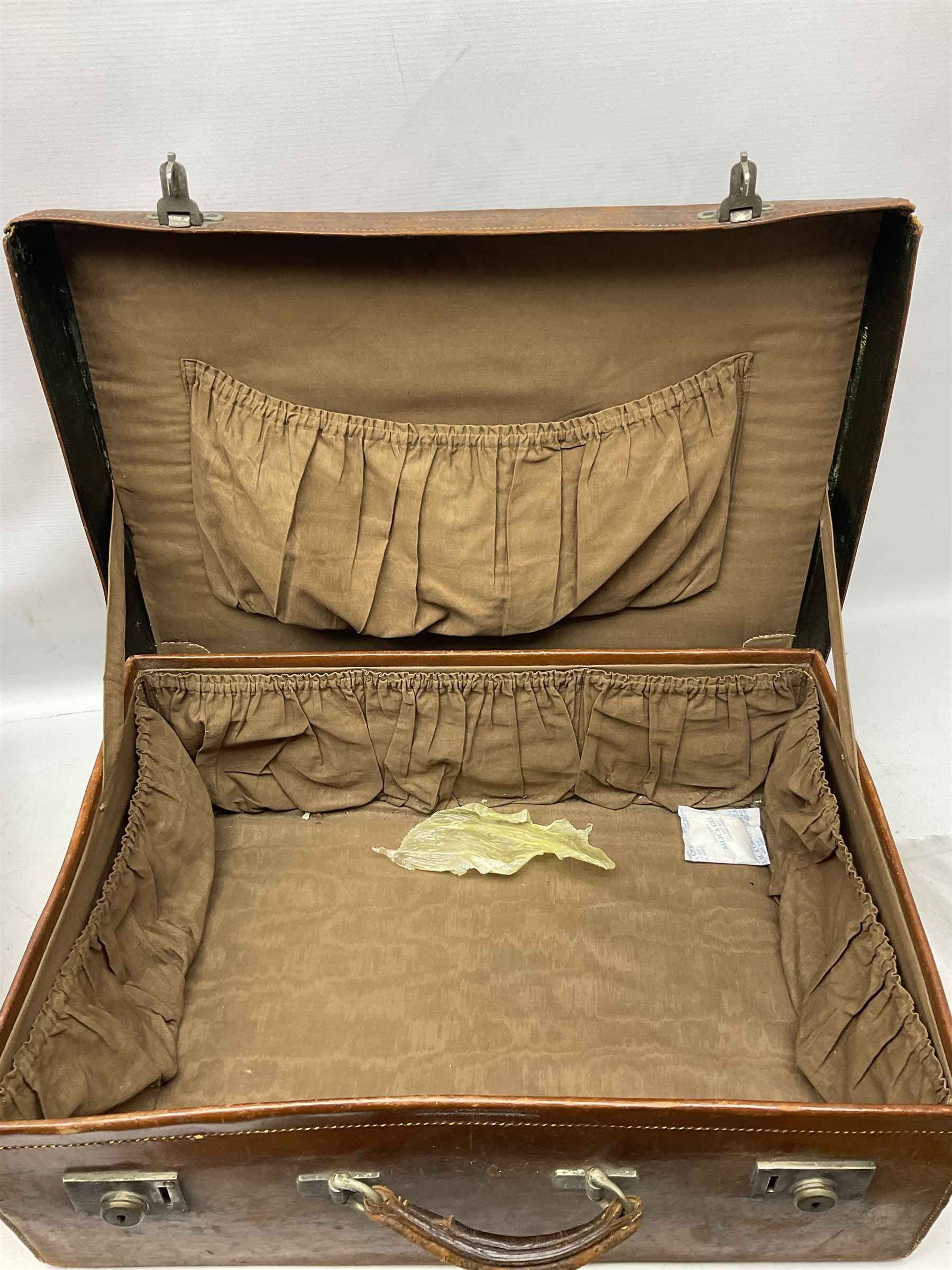 Early 20th century leather suitcase marked to the top 'Major P.M. Newton R.E. Crossways, Bridlington, East Yorkshire' 60 x 40cm; another similar leather suitcase marked W.D. to the lid; three post-WW2 respirators; and three unopened pairs of British Army N.B.C. (Nuclear Biological Chemical) No.1 Mk.III Trousers Protective (8)