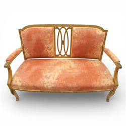 Edwardian satinwood settee, the shaped and bowed top rail enclosing a pierced splat with interlaced oval slats, flanked by upholstered back panels, the padded arms with scrolling terminals, the upholstered seat raised on cabriole supports with pad feet