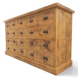 Indigo Furniture - large rustic oak combination chest sideboard, fourteen drawer with blackened metal cup handles, on a plinth base