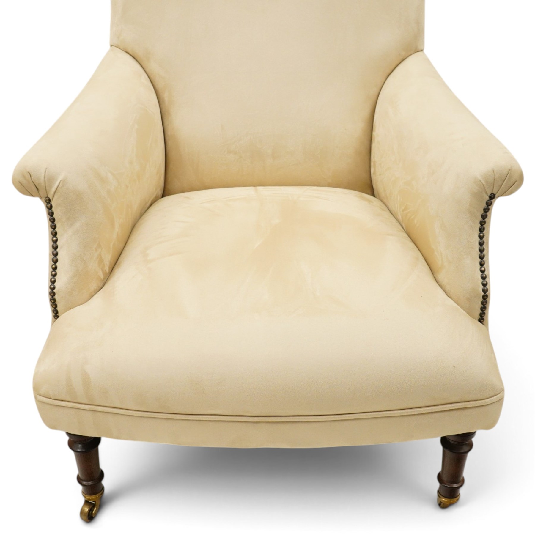 Sofas & Stuff - pair of ‘Thistle’ armchairs upholstered in neutral fabric, each with gently sloping back, padded scroll arms with close-set stud detailing, loose seat cushions, raised on turned wooden legs with brass castors