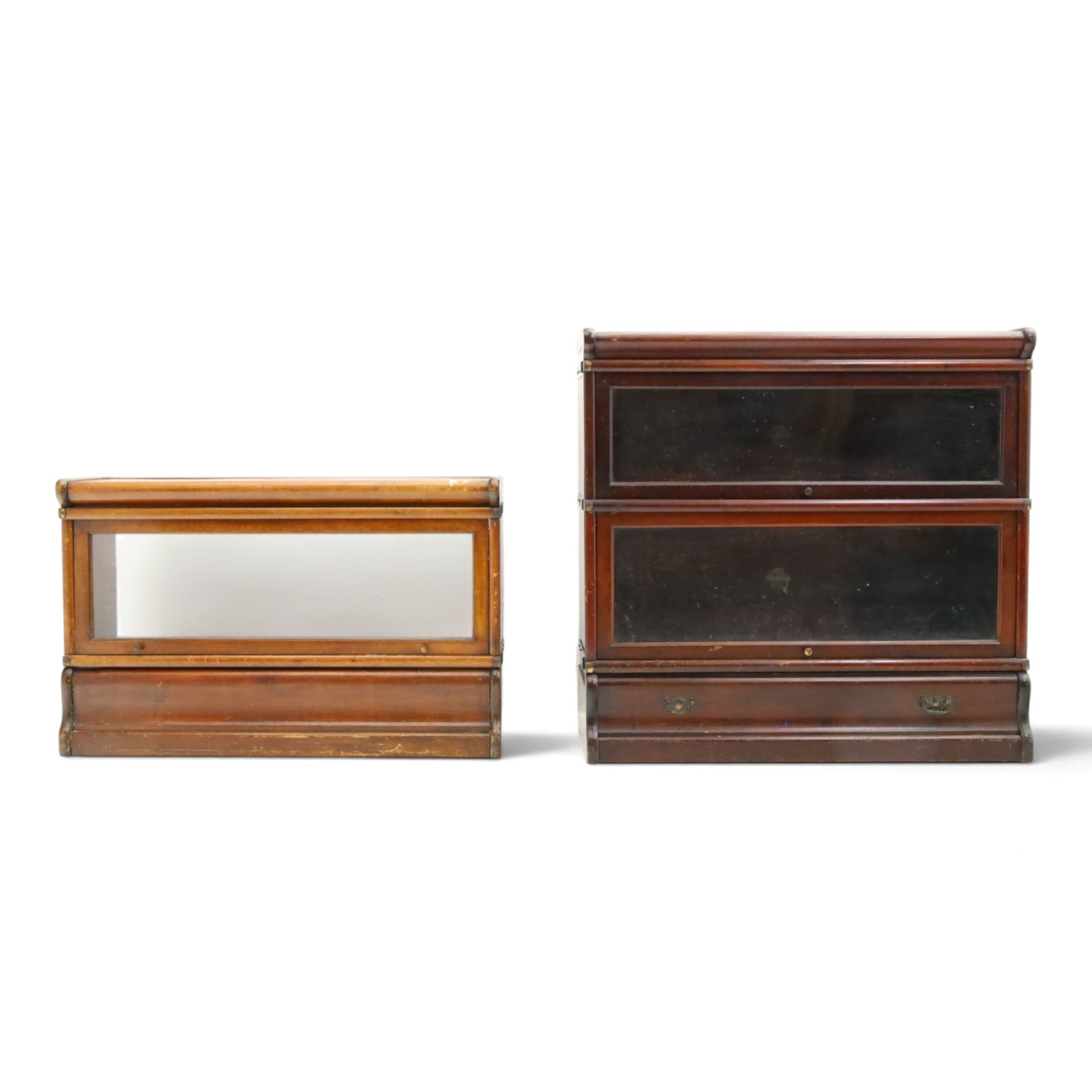 Globe Wernicke - early 20th century mahogany two-tier stacking library bookcase, fitted with glazed up-and-over doors, two drawers to the plinth base; together with a similar single-tier example (W87cm D27cm H54cm)