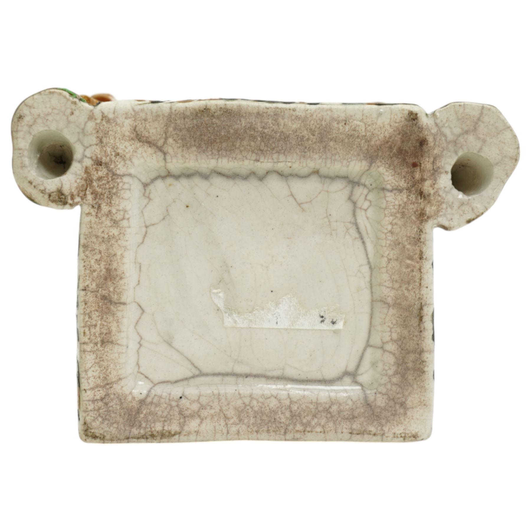 Yorkshire Prattware cottage, circa. 1820, in shades of blue, ochre and white, moulded in relief with two flanking gentlemen figures, H12cm 