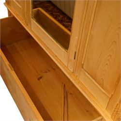 Victorian waxed pine wardrobe, carved projecting cornice with mirrored door, enclosing clothes hooks and rail, above a single drawer with glass knobs