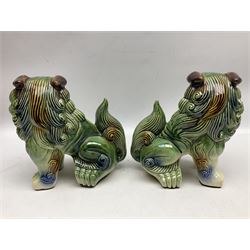Pair of Chinese stoneware Fo dogs with merging green, brown and blue glaze, H22cm