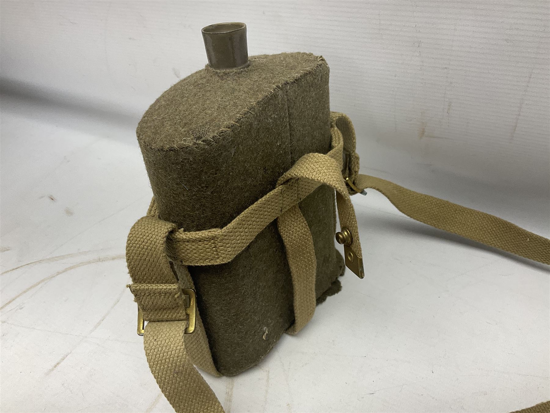 Mundial Brazil bowie knife, the 15.5cm steel blade inscribed 'Sheriff Knife', with banded and aluminium hilt; in leather sheath L29cm overall; British Army felt covered metal water bottle with webbing strap; leather 12-bore cartridge belt; and small pair of non-military binoculars in part case (4)