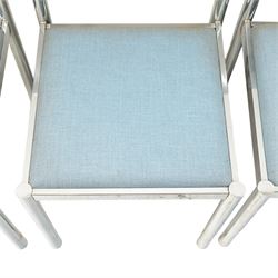 Set of eight 1980s chrome and upholstered dining chairs, curved back bar over padded seats upholstered in blue fabric, on tubular chrome frames