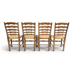 Set of eight country ladderback chairs (6+2), shaped ladderback over a rush seat, raised on turned supports, united by stretchers