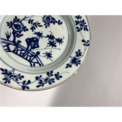 Three late 18th/early 19th century Chinese export dishes, of circular form decorated with central panel of plantain and bamboo within lattice and foliate borders, D23cm, together with two further dishes, the first example decorated with crane and tree, the second with blossoming flowers and fence, each D22.5cm