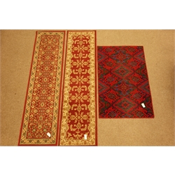  Two Persian design runner rugs, another rug and a wall hanging  