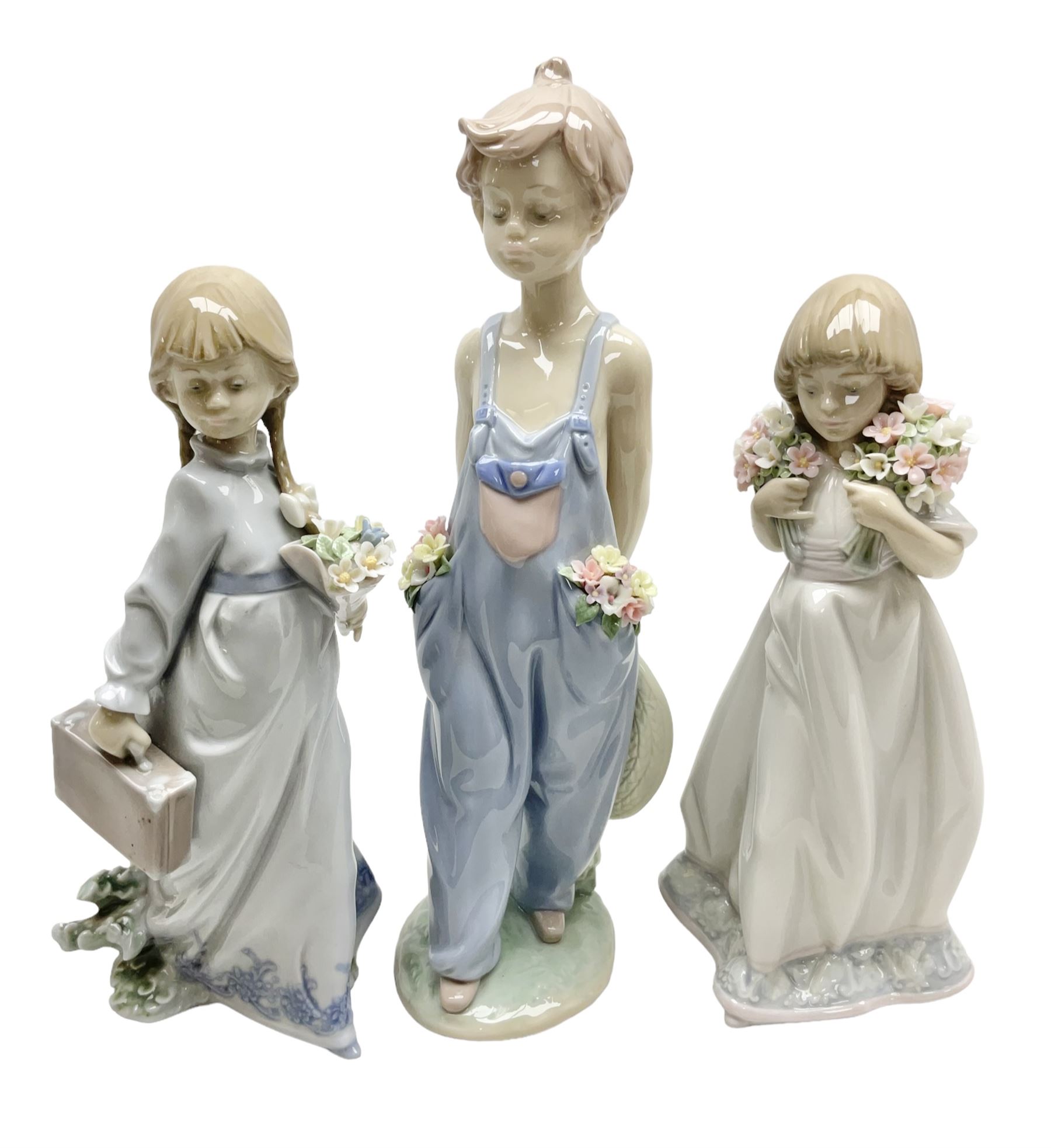 Three Lladro figures comprising, Pocket Full of Wishes no 7650, School Days no 7604 and Spring Bouquets no 7603, all with original boxes, largest example H26cm  