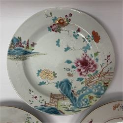 Three 18th century Chinese Famille Rose plates, the first example enamelled with blossoming peonies, rockwork and fence, the other two examples of similar design, decorated with blossoming peonies and sprigs within shaped inner borders, each approximately D23cm