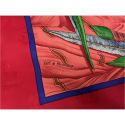 Hermès 'Christophe Colomb Découvre l'Amérique' jacquard silk scarf, designed by Carl de Parcevaux in 1992, limited edition for the bi-centenary of the discovery of America, printed with a central image of Christopher Columbus' ship at sea, surrounded with colourful stylised feathers, birds, flags, globes, shells and flowers, contained within vibrant red border, with rolled hand stitched edges and Hermes material label, 87cm square
