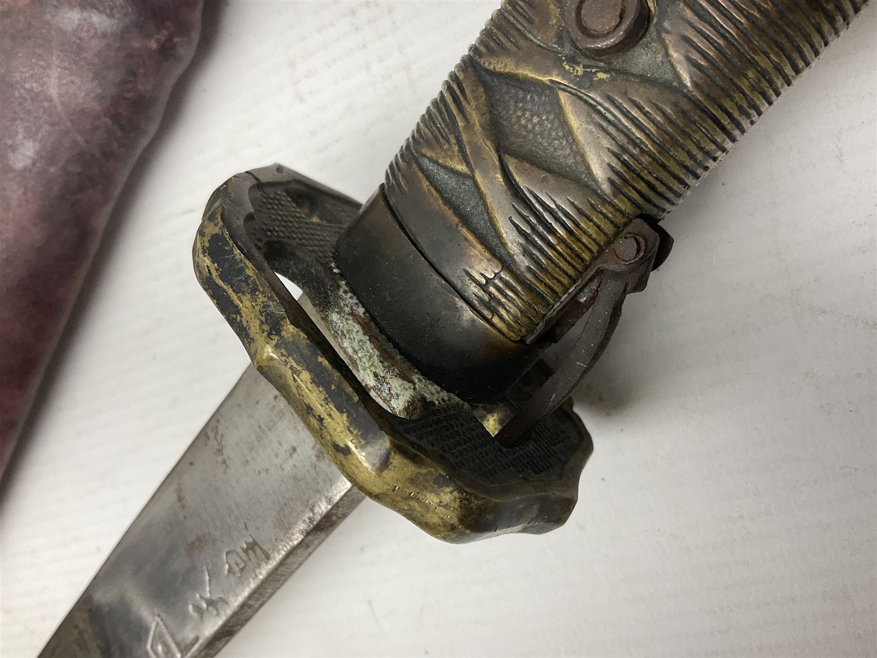 Copy of a WWII Japanese NCO sword, the 65cm slightly curving blade stamped with pseudo Japanese characters and cast brass simulated cord bound grip; in officer's leather bound field scabbard L97cm overall