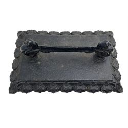 Victorian black-painted cast iron boot scraper, mythical ornithomorphic cast supports, on rectangular plinth with stylised leaf moulded edge 