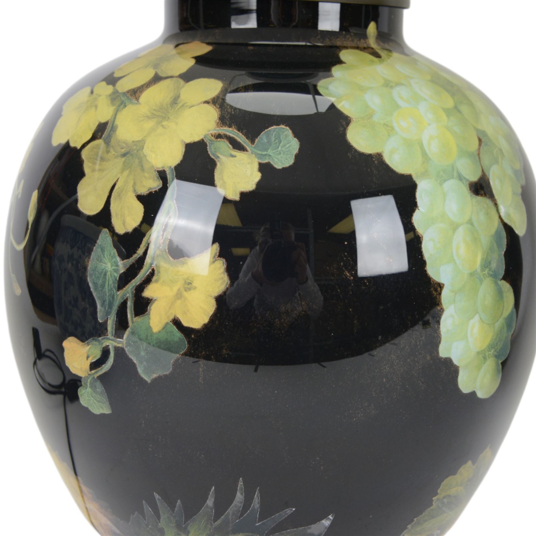 Pair of Jenny Worrall table lamps, of ovoid form, the glass body decorated with fruit and trailing flowers upon a black ground with gilt flecks, with pleated cream lampshades, including shades H65cm