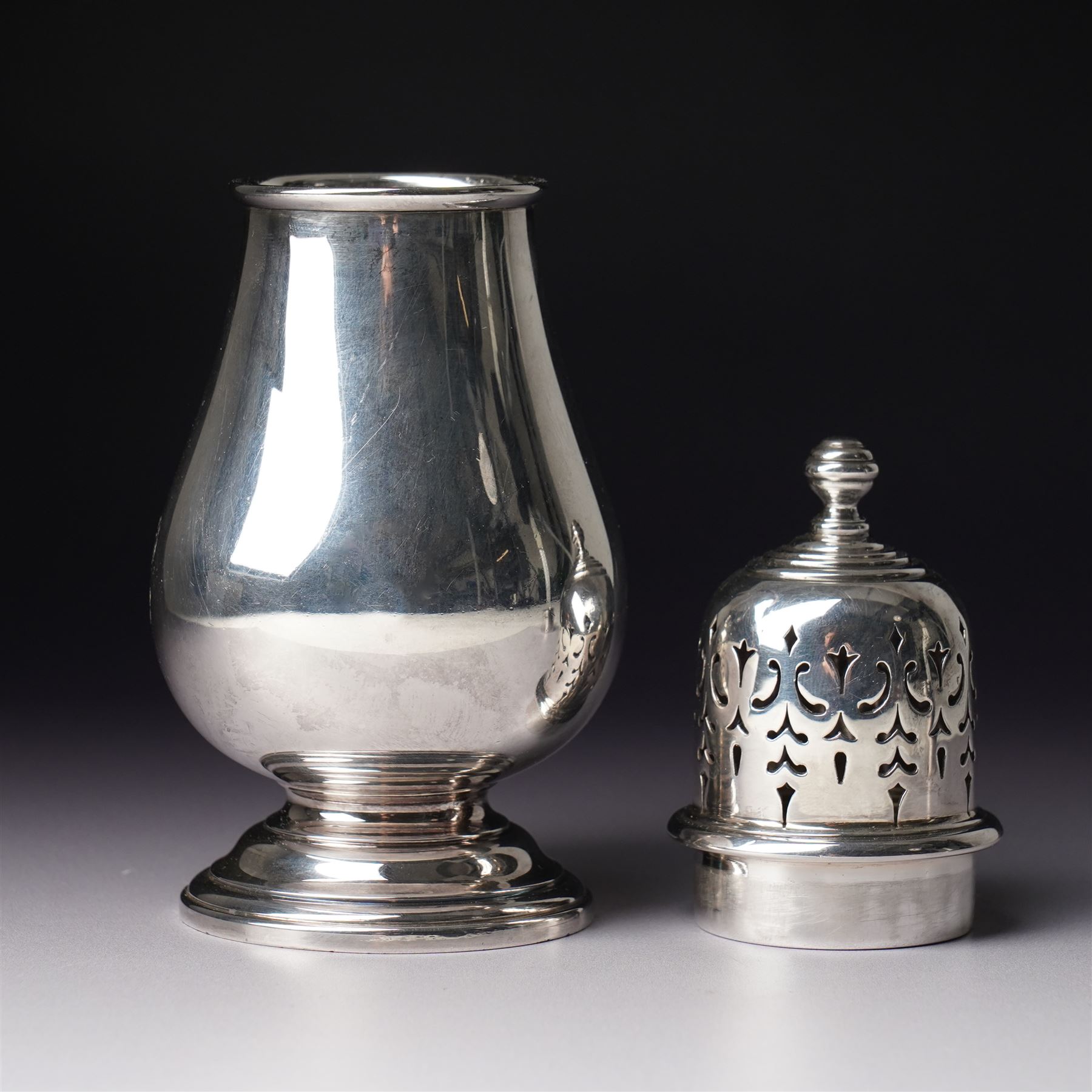 Georg Jensen sterling silver spirit measure of Art Deco design with flattened handle and a silver sugar caster Birmingham 1959